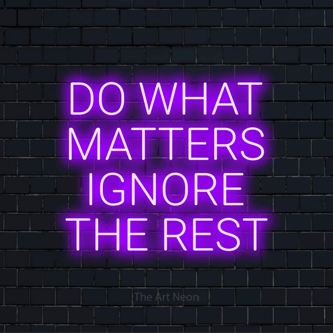 "Do What Matters Ignore The Rest" LED neon sign on a black brick wall