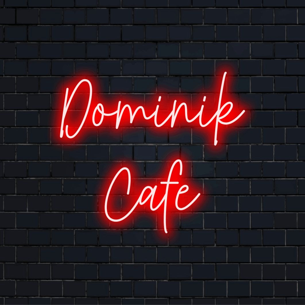 Dominik Cafe Personalized LED Neon Sign, glowing lettering on dark brick wall