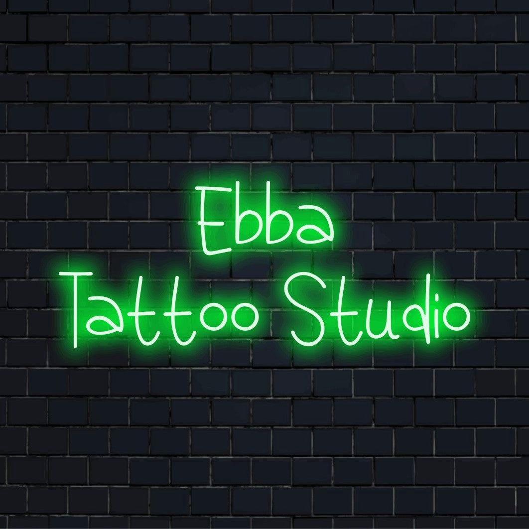 Ebba Tattoo Studio Personalized LED Neon Sign, bright neon lettering on dark brick wall