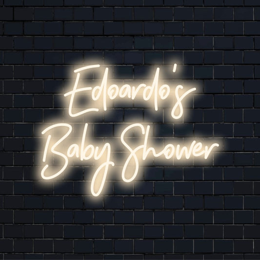 Edoardo_s Baby Shower Personalized Neon Light with bright neon lettering on dark brick wall