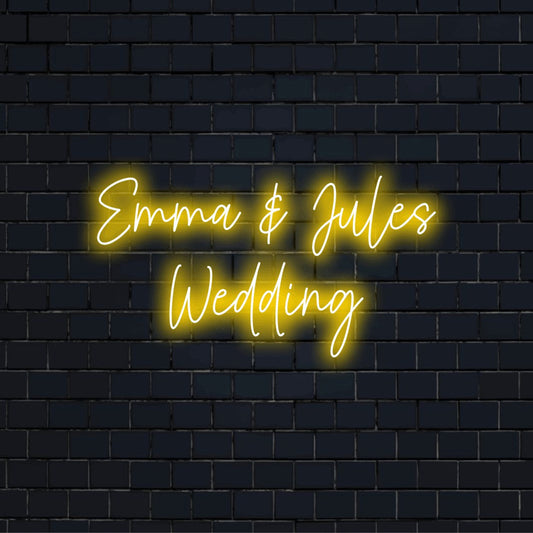 Emma _ Jules Wedding Personalized LED Neon Sign, glowing neon text against black brick wall