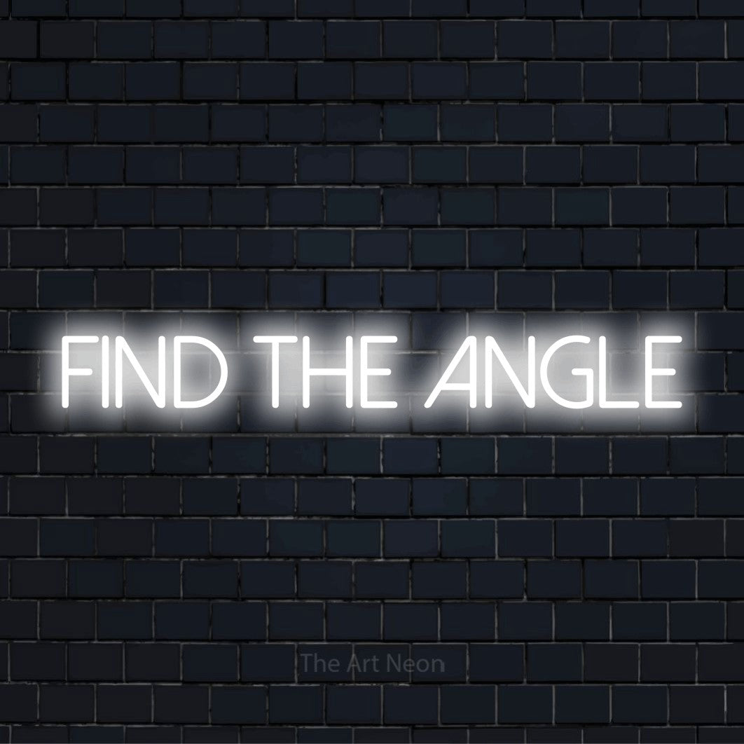 "Find The Angle" neon text design on a black brick wall