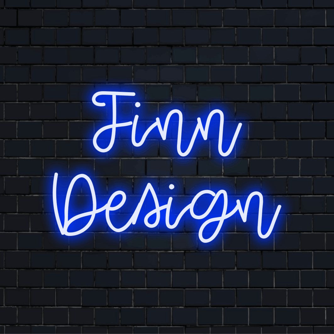 Finn Design Personalized Neon Light with bright neon lettering against brick backdrop