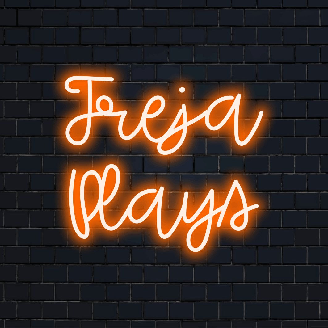Freja Plays Personalized Neon Light with bright neon lettering against brick backdrop