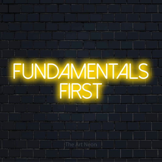 "Fundamentals First" glowing LED neon sign on a black brick wall