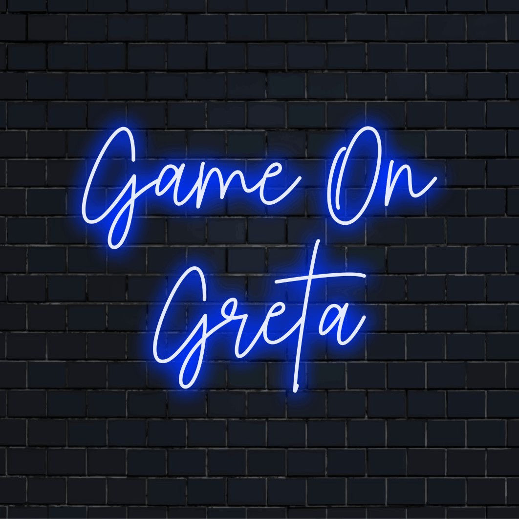 Game On Greta Custom Name Neon Sign, neon text light on dark brick background