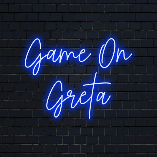 Game On Greta Custom Name Neon Sign, neon text light on dark brick background