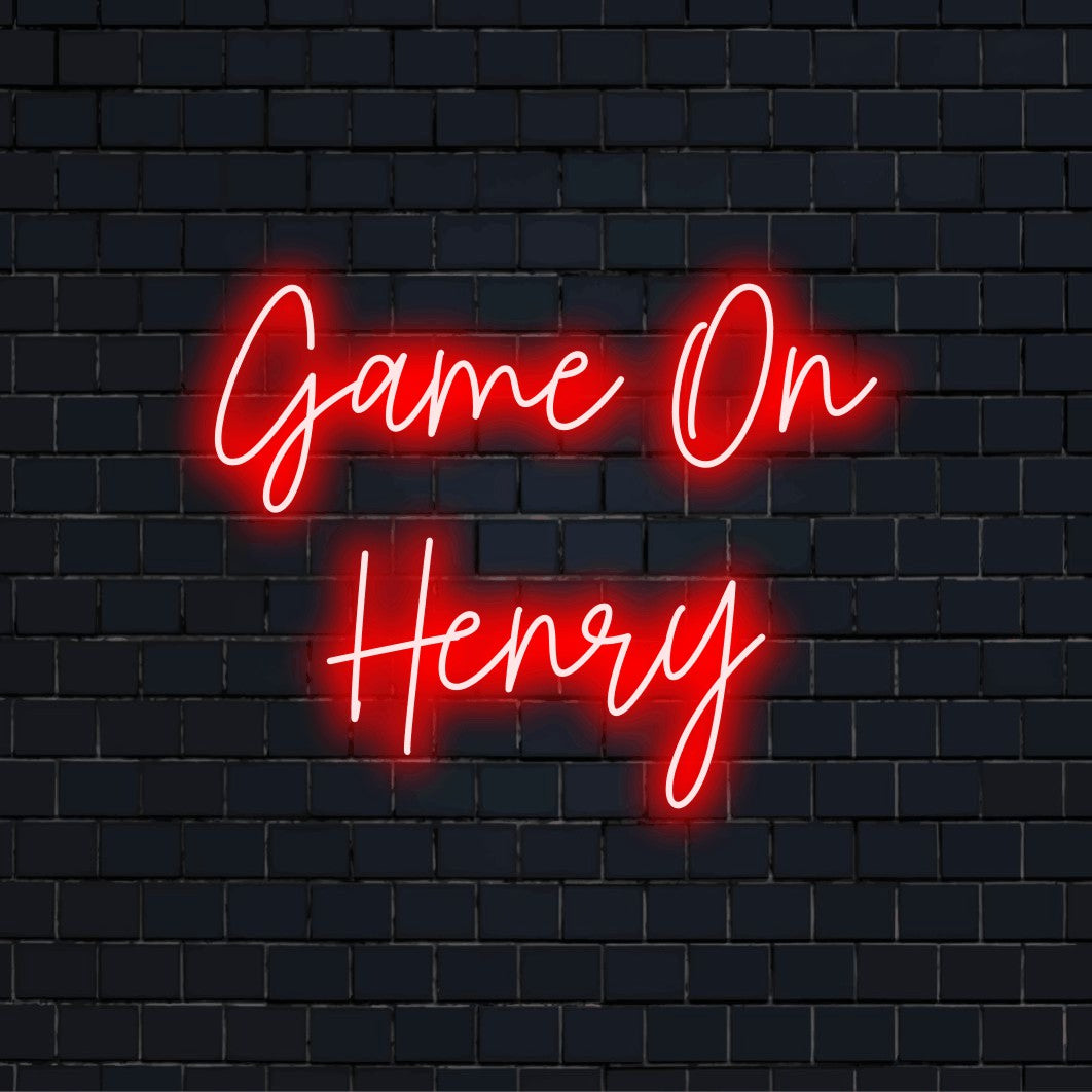 Game On Henry Personalized Neon Light with bright neon lettering against brick backdrop