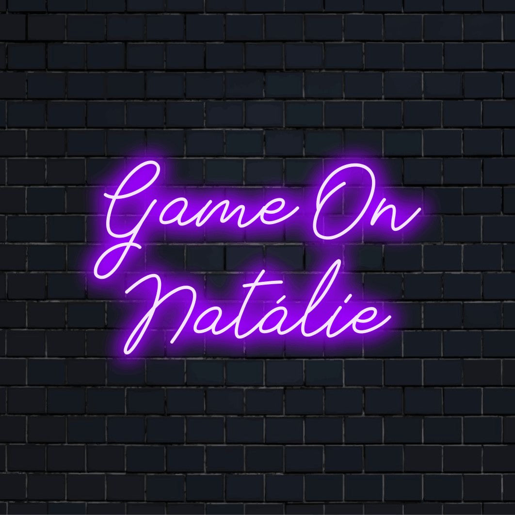 Game On Natalie Custom Name Neon Sign, glowing lettering on dark brick wall