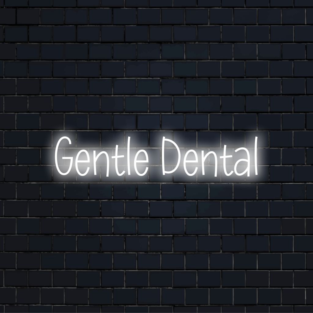 Gentle Dental Neon Sign, bright neon lettering against brick backdrop