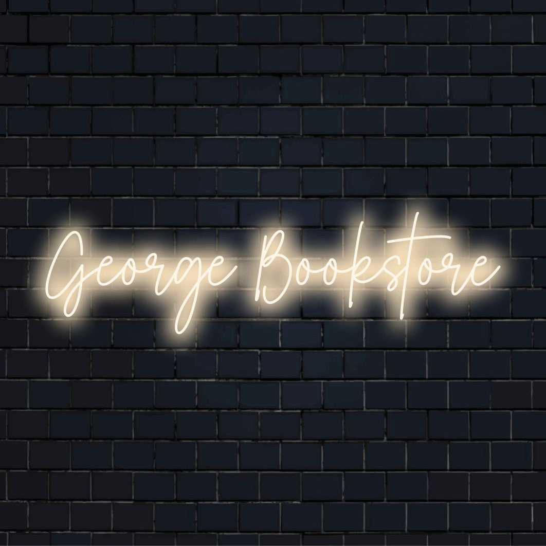 George Bookstore Personalized Neon Light with soft neon glow against brick backdrop