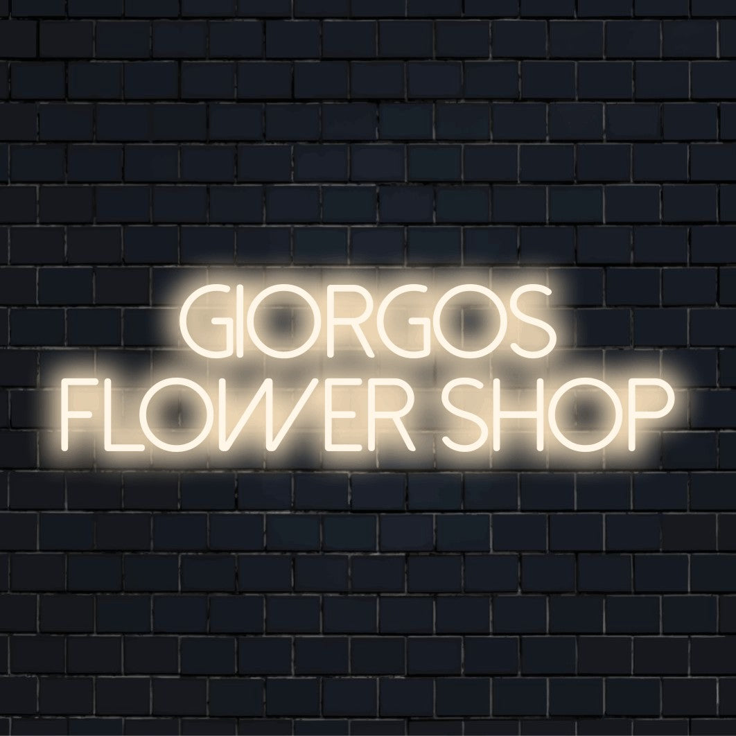 Giorgos Flower Shop Custom Name Neon Sign, neon text light on dark brick wall