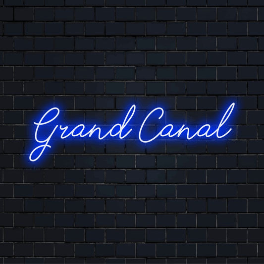 Grand Canal Neon Sign, glowing wall decor against brick backdrop