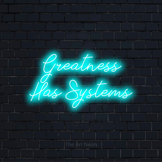 "Greatness Has Systems" glowing LED neon sign on a black brick wall