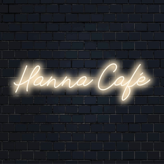 Hanna Cafe Personalized LED Neon Sign, bright neon glow on dark brick wall