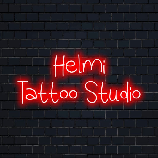Helmi Tattoo Studio Personalized Neon Light with glowing lettering against brick backdrop