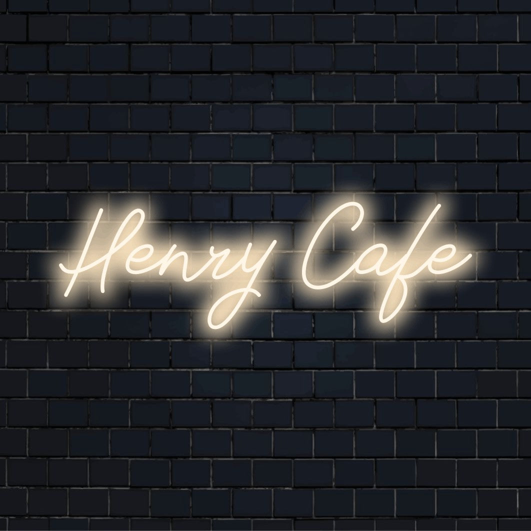 Henry Cafe Custom Name Neon Sign, bright neon lettering on dark brick wall