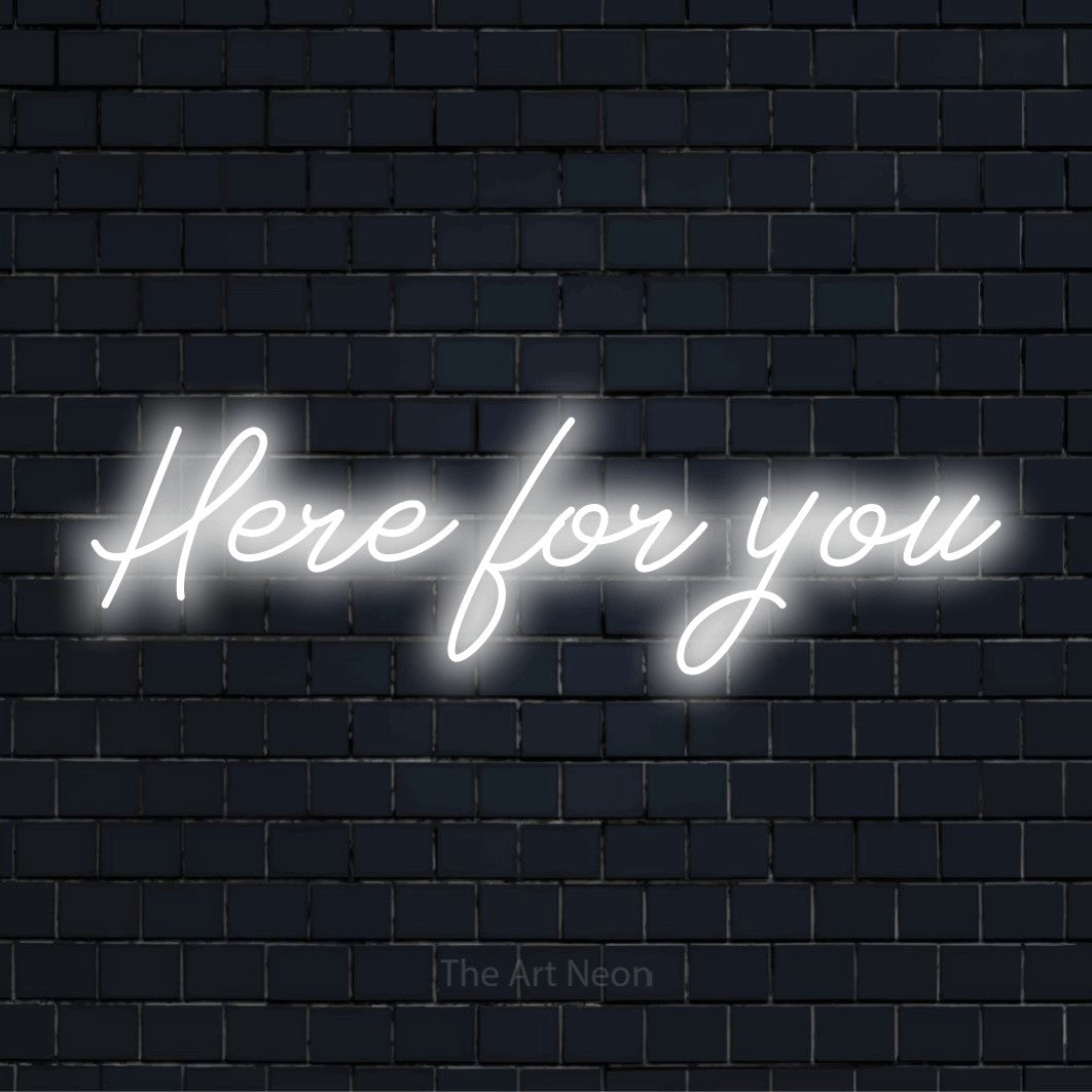 "Here For You" script-style LED neon sign on a black brick wall