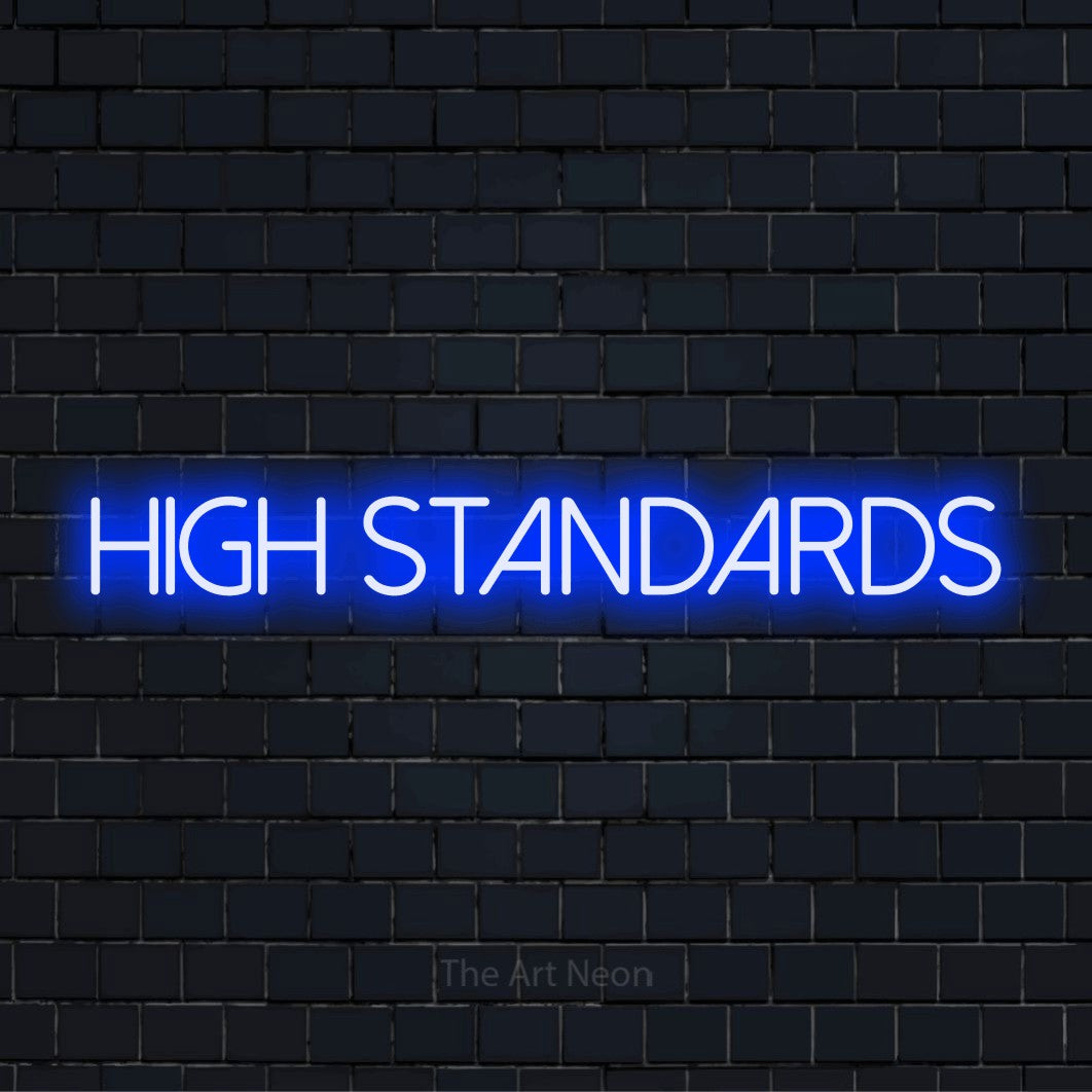 "High Standards" script-style LED neon sign on a black brick wall