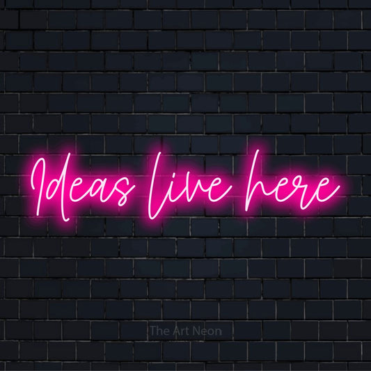 "Ideas Live Here" neon text design on a black brick wall