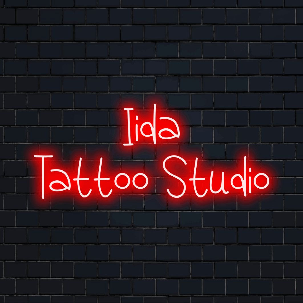 Iida Tattoo Studio Personalized LED Neon Sign, bright neon glow on black brick background