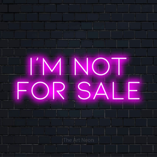 "I’m Not For Sale" neon text design on a black brick wall