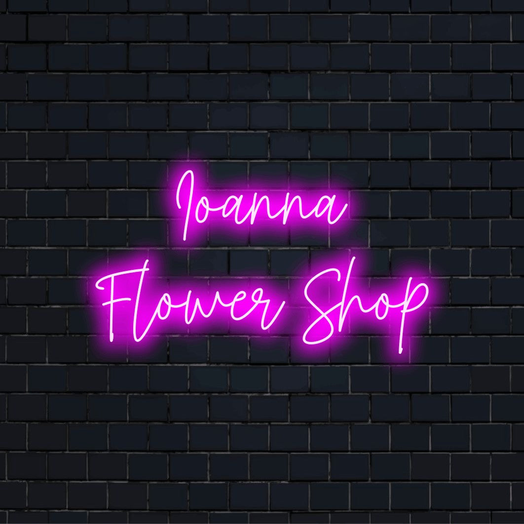 Ioanna Flower Shop Custom Name Neon Sign, glowing lettering on black brick background