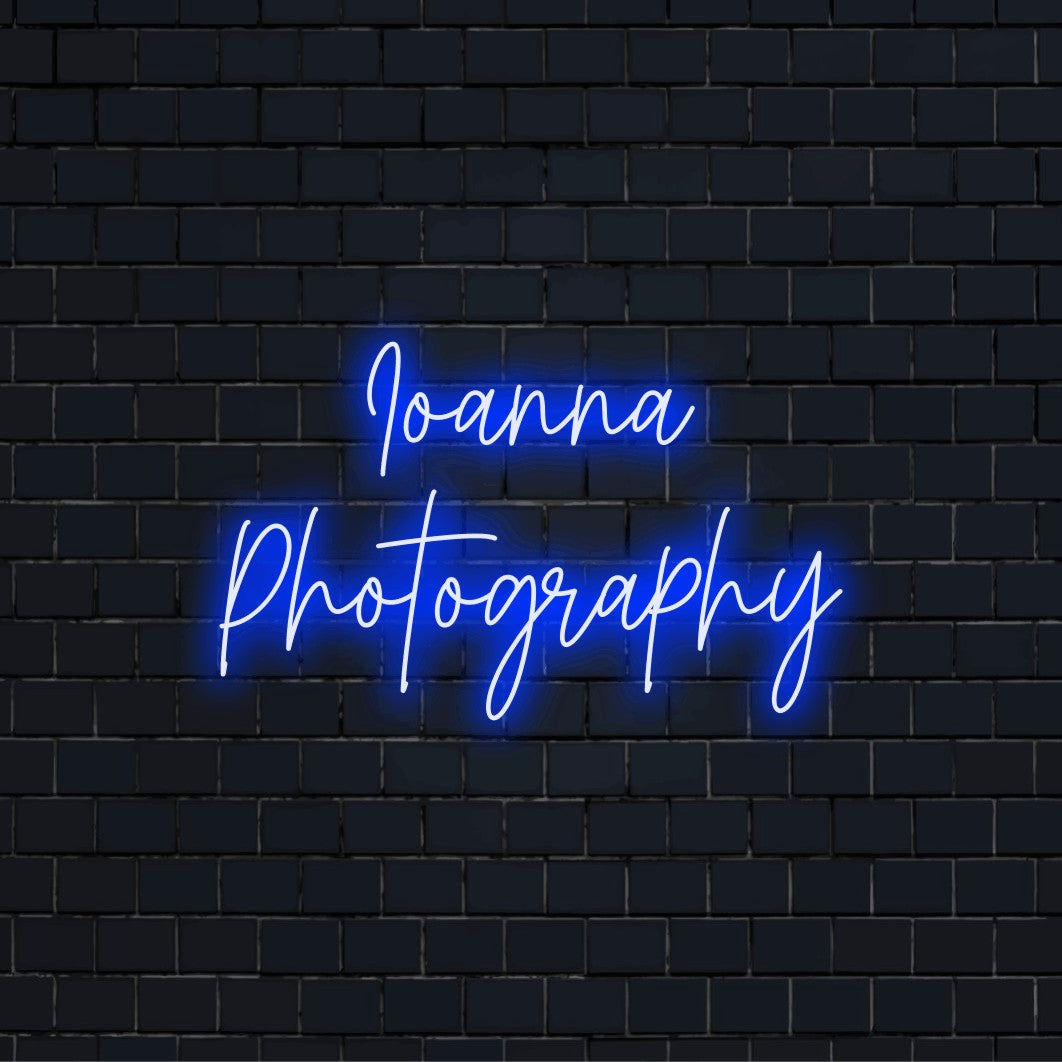 Ioanna Photography Personalized Neon Light with glowing lettering against black brick wall