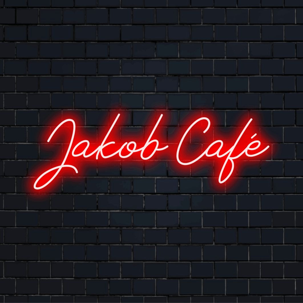 Jakob Cafe Personalized Neon Light with soft neon glow on black brick background