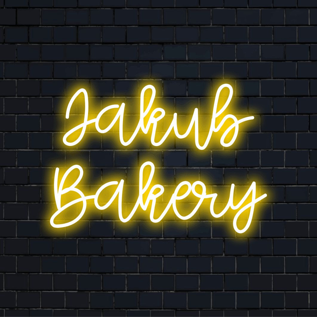 Jakub Bakery Custom Name Neon Sign, soft neon glow on dark brick wall