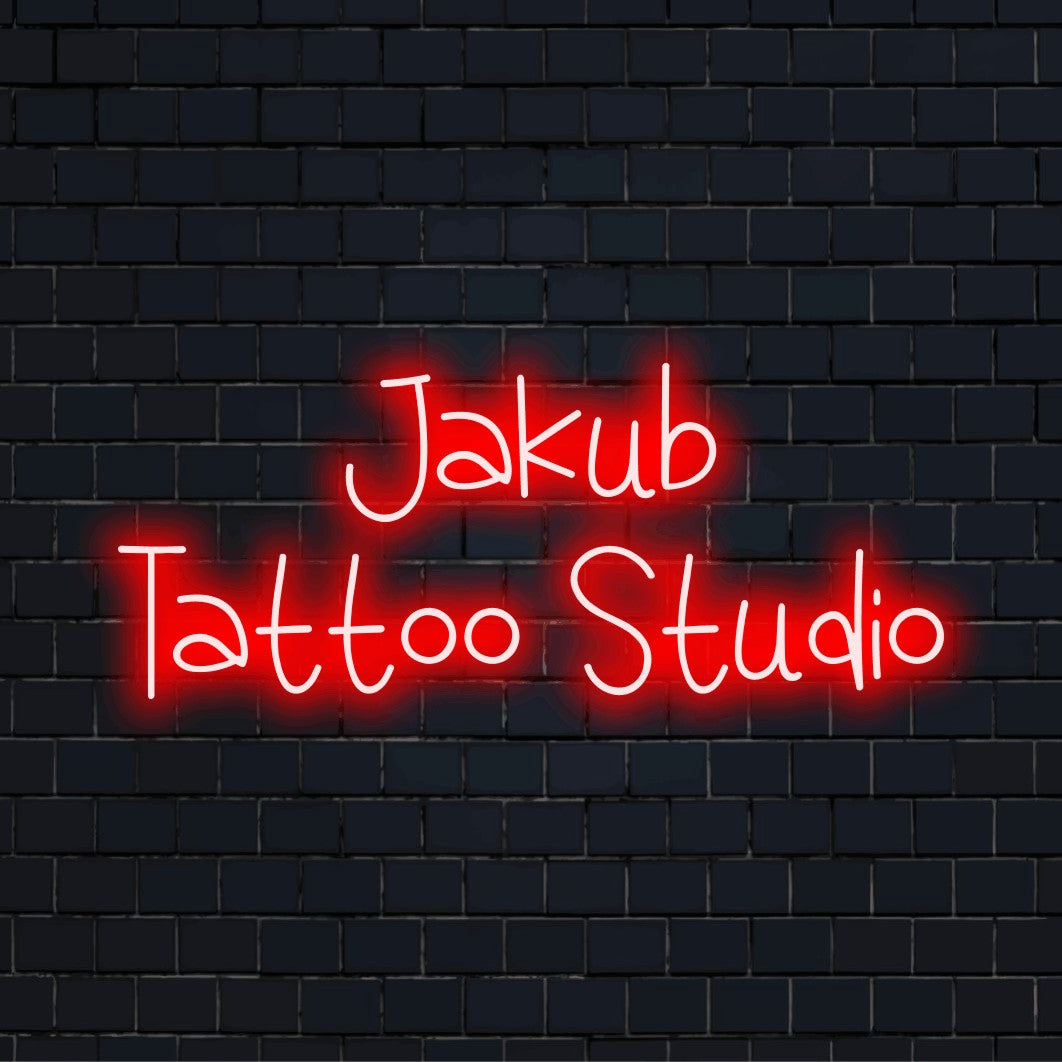 Jakub Tattoo Studio Personalized LED Neon Sign, neon text light against black brick wall