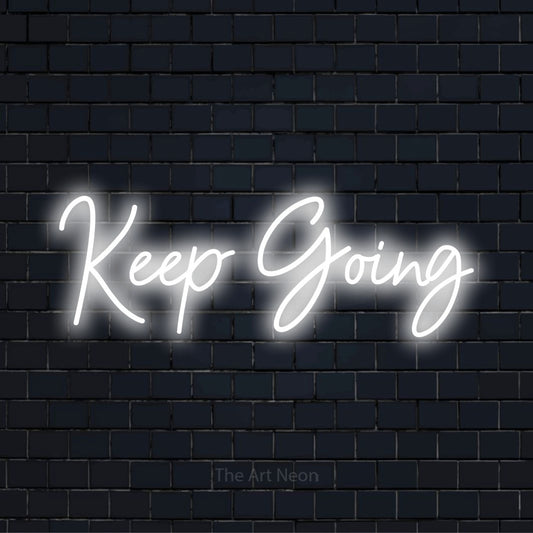 "Keep Going" text design with neon effect on a black brick wall