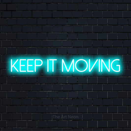 "Keep It Moving" LED neon sign on a black brick wall