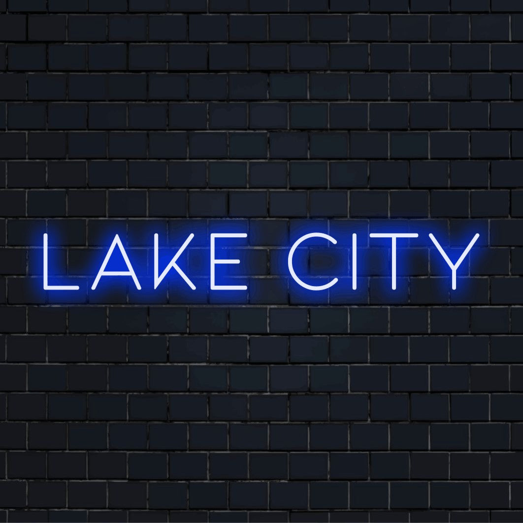 Lake City Neon Sign, bright neon glow on dark brick background