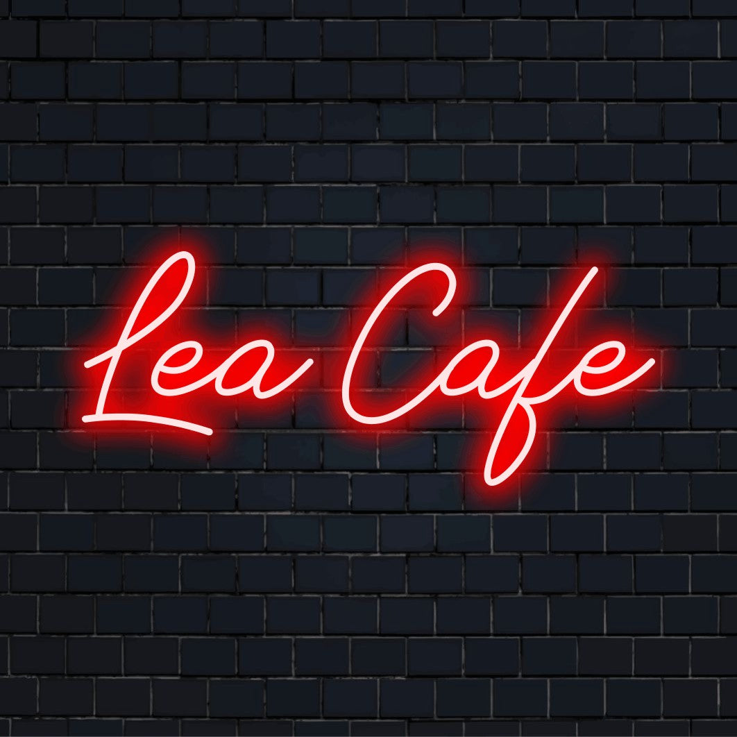 Lea Cafe Personalized LED Neon Sign, glowing neon text against black brick wall