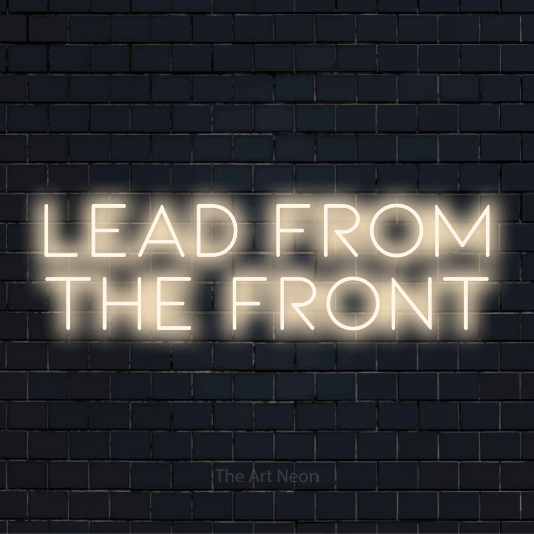 "Lead From The Front" LED neon sign on a black brick wall