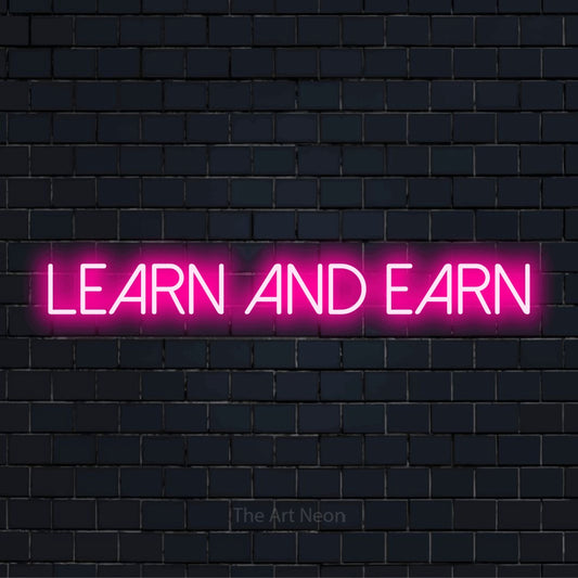 "Learn And Earn" script-style LED neon sign on a black brick wall