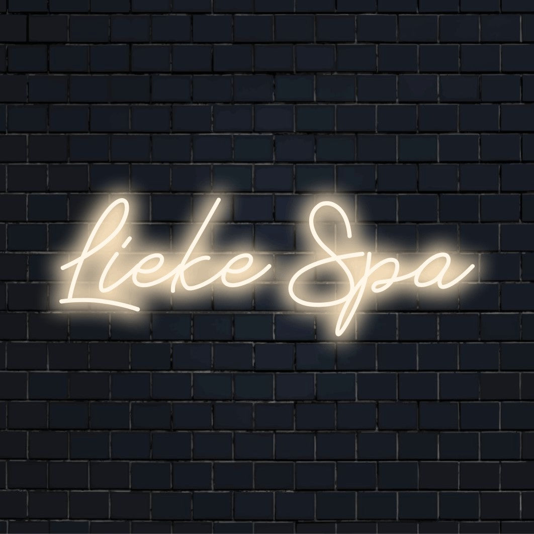 Lieke Spa Custom Name Neon Sign, glowing lettering against brick backdrop