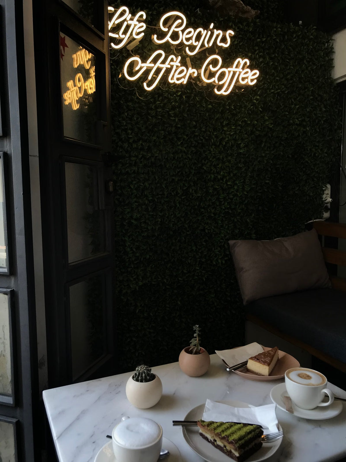 Life Begins After Coffee LED neon phrase inside a café