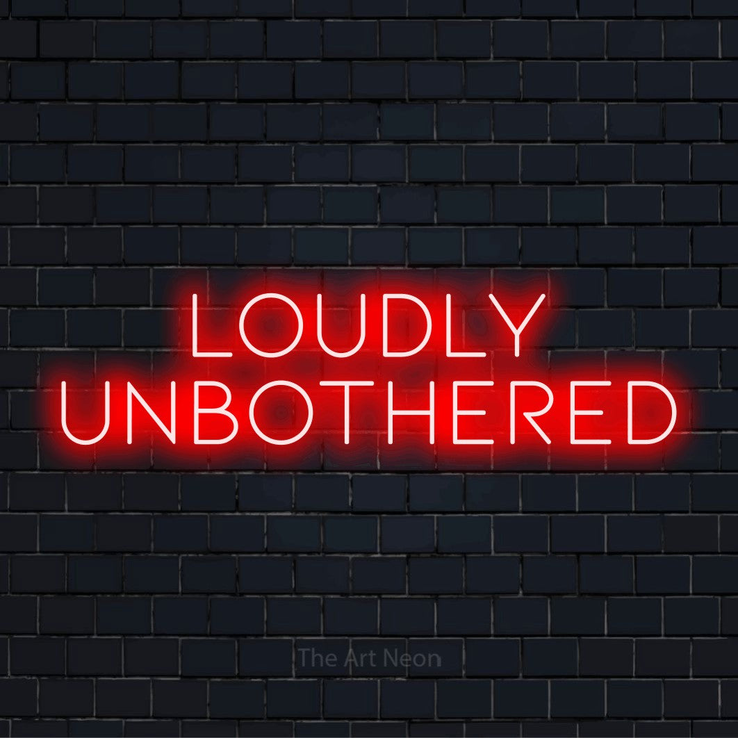 "Loudly Unbothered" text design with neon effect on a black brick wall