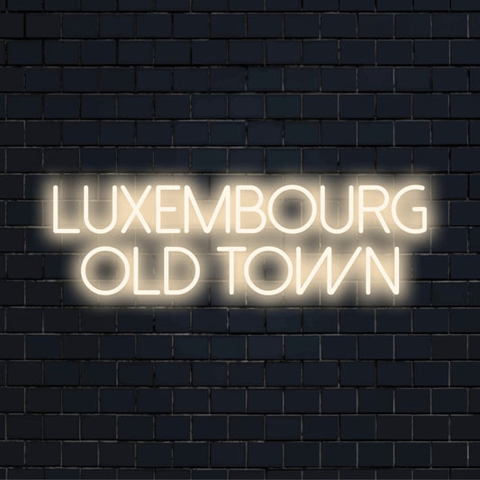 Luxembourg Old Town Neon Sign, bright neon lettering on dark brick background