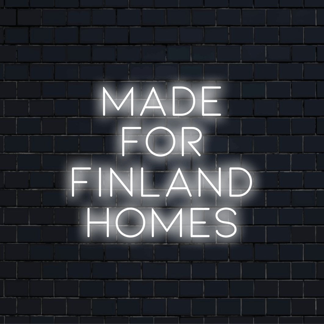 Made For Finland Homes Neon Sign, glowing lettering on black brick background