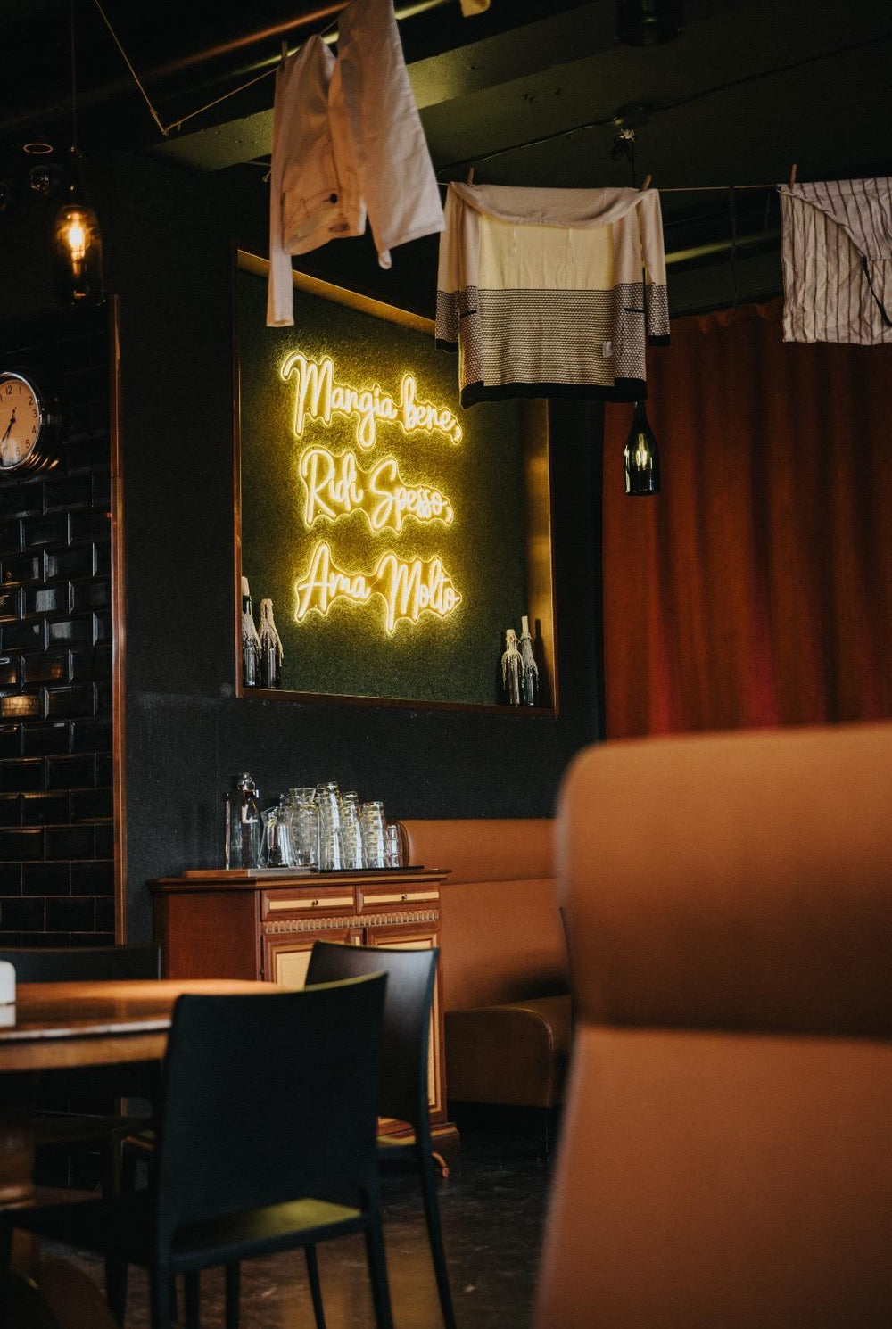 Green LED neon sign installed in a restaurant dining space