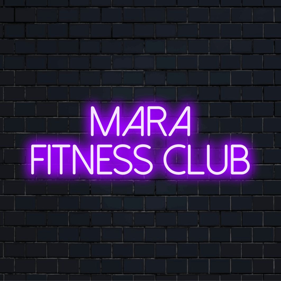 Mara Fitness Club Personalized Neon Light with glowing wall decor against black brick wall