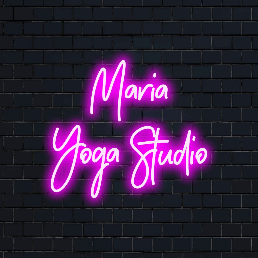 Maria Yoga Studio Personalized LED Neon Sign, glowing wall decor against brick backdrop