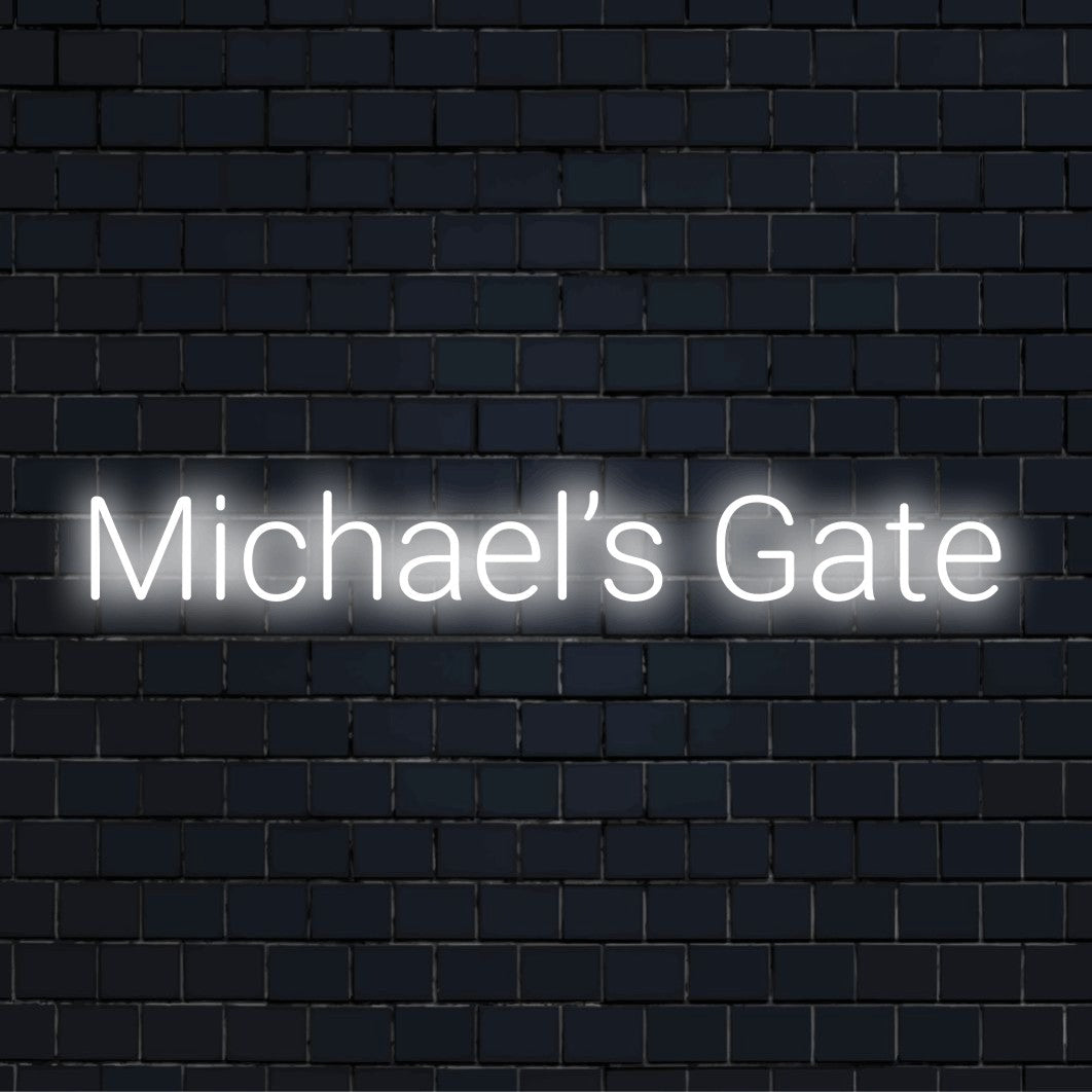 Michael S Gate Neon Sign, glowing wall decor on dark brick wall