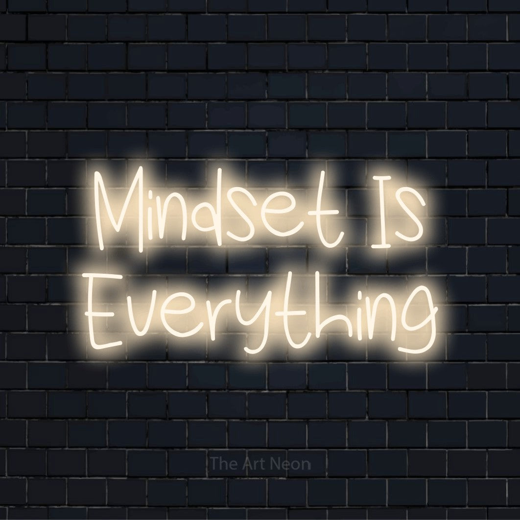 "Mindset Is Everything" neon text design on a black brick wall