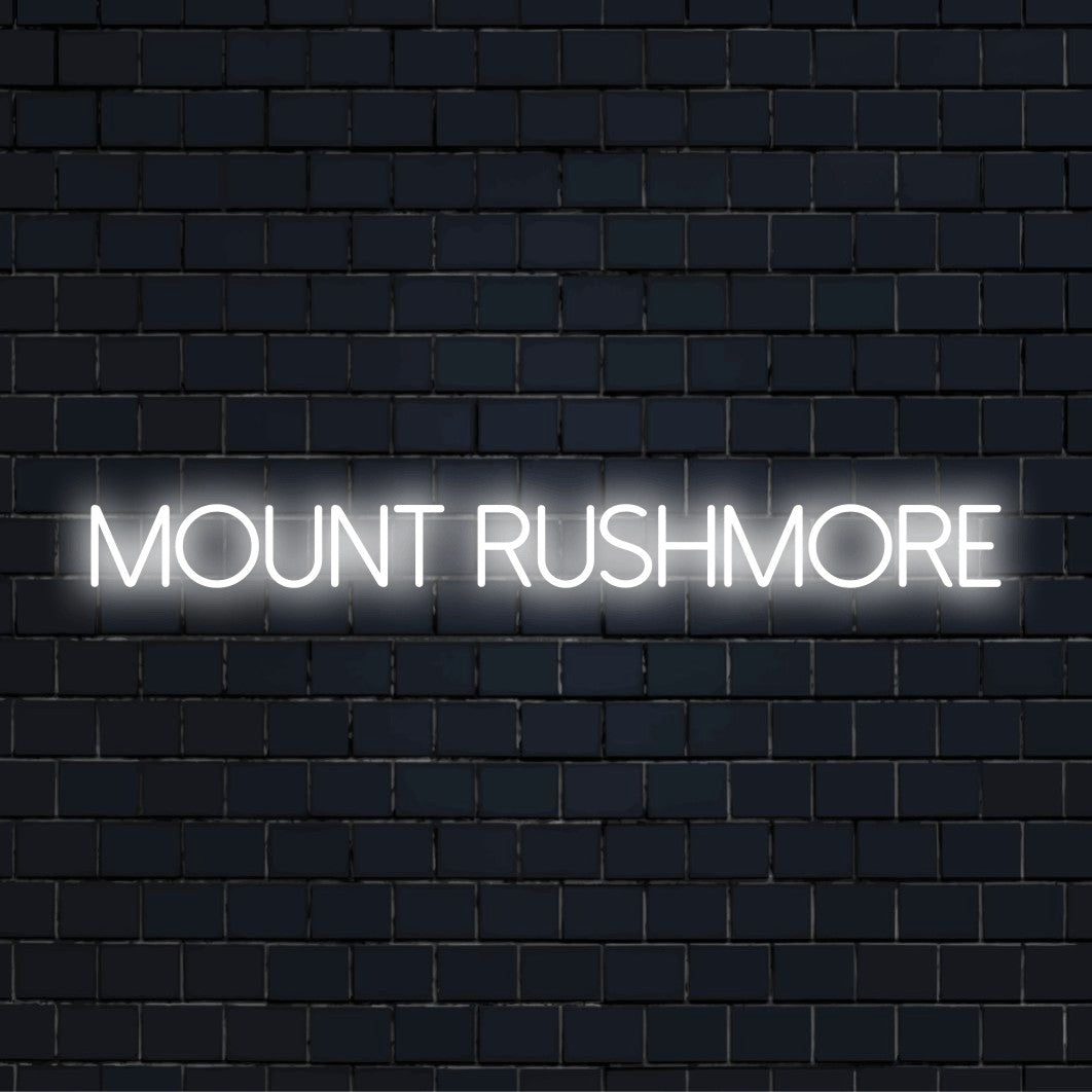 Mount Rushmore Neon Sign, glowing lettering on black brick background