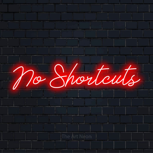 "No Shortcuts" neon text design on a black brick wall