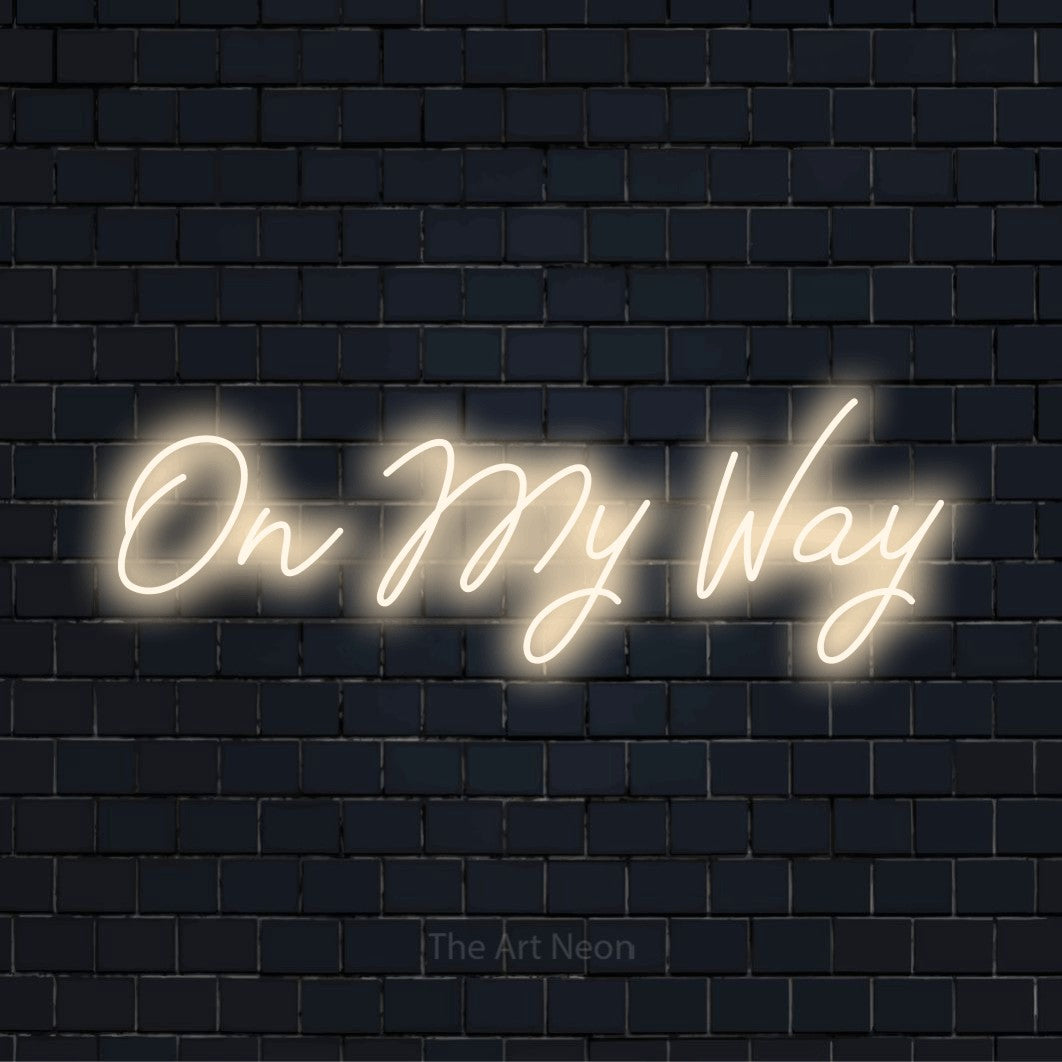 "On My Way" glowing LED neon sign on a black brick wall